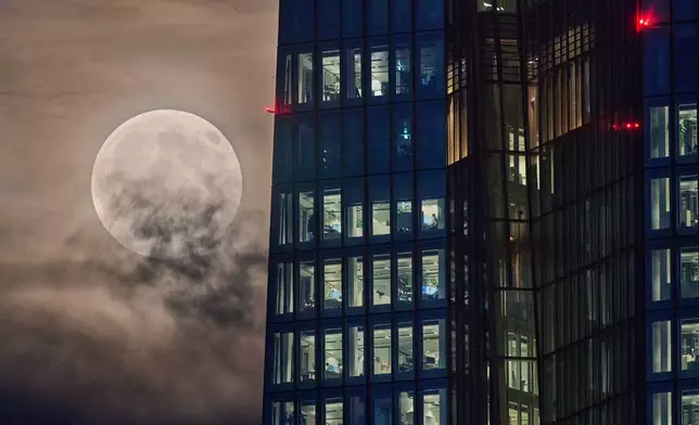 The beaver moon rises next to the European Central Bank in Frankfurt, Germany, Wednesday, Nov. 5, 2025. (AP Photo/Michael Probst)