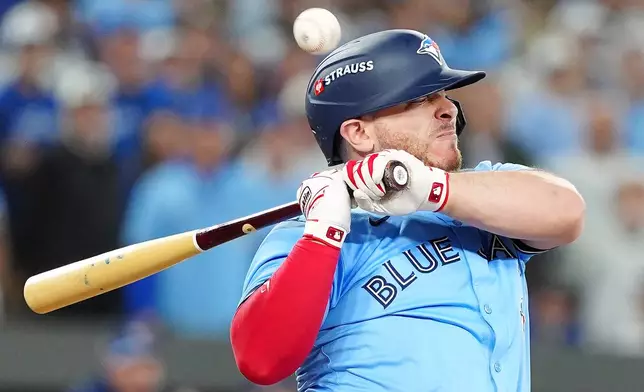 Toronto Blue Jays' Alejandro Kirk reacts after being hit by a pitch during the ninth inning in Game 6 of baseball's World Series against the Los Angeles Dodgers in Toronto, Friday, Oct. 31, 2025. (Frank Gunn/The Canadian Press via AP)