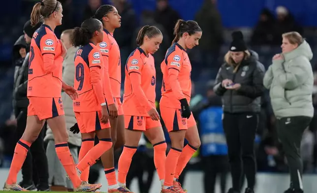 Barcelona's Aitana Bonmati, right, and her teammates leave the pitch at the the end of the women's Champions League opening phase soccer match between Chelsea FC and FC Barcelona, in London, Thursday, Nov. 20, 2025. (AP Photo/Kin Cheung)