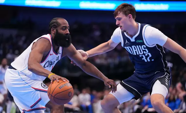 Los Angeles Clippers guard James Harden, left, works the floor against Dallas Mavericks forward Cooper Flagg during the second half of an NBA Cup basketball game Friday, Nov. 14, 2025, in Dallas. (AP Photo/Julio Cortez)