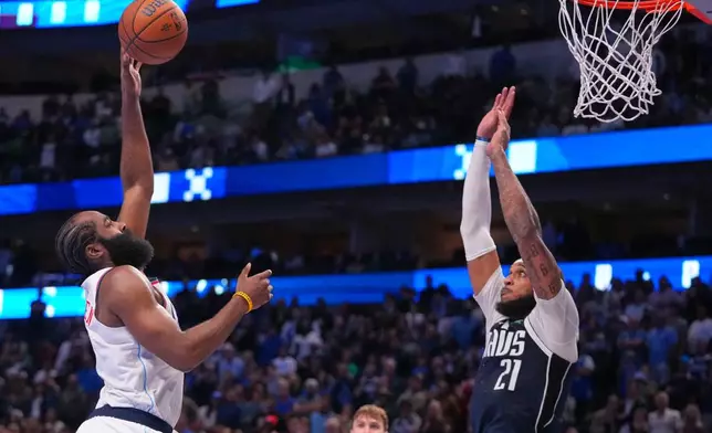 Los Angeles Clippers guard James Harden, left, goes up for a basket against Dallas Mavericks forward Daniel Gafford during overtime of an NBA Cup basketball game Friday, Nov. 14, 2025, in Dallas. (AP Photo/Julio Cortez)