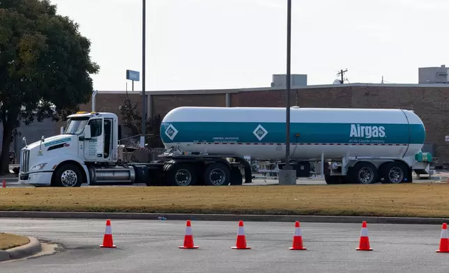An Airgas semi truck that leaked ammonia sits behind the Holiday Inn Express in Weatherford, Okla. on Thursday, Nov. 13, 2025. (AP Photo/Alonzo Adams)