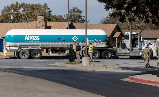 Crews begin checking the Airgas tanker on Thursday, Nov. 13, 2025 that leaked in the parking lot of the Holiday Inn Express in Weatherford, Okla. the previous night and caused mandatory evacuations. (AP Photo/Alonzo Adams)