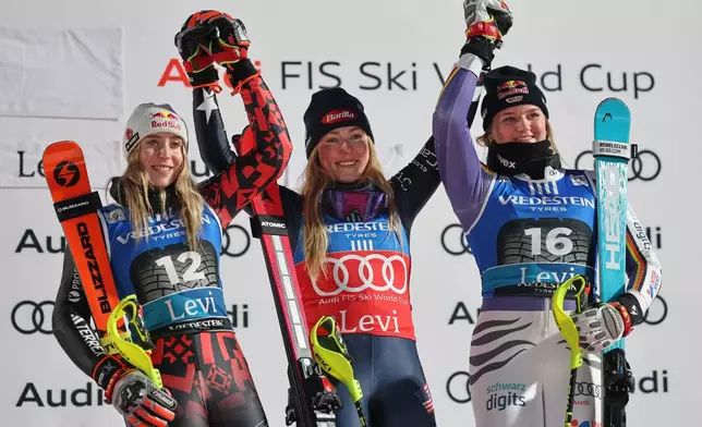 United States' Mikaela Shiffrin, center, winner of an alpine ski, women's World Cup slalom, poses on the podium with second placed Albania's Lara Colturi, left, and third placed Germany's Emma Aicher, in Levi, Finland, Saturday, Nov. 15, 2025.