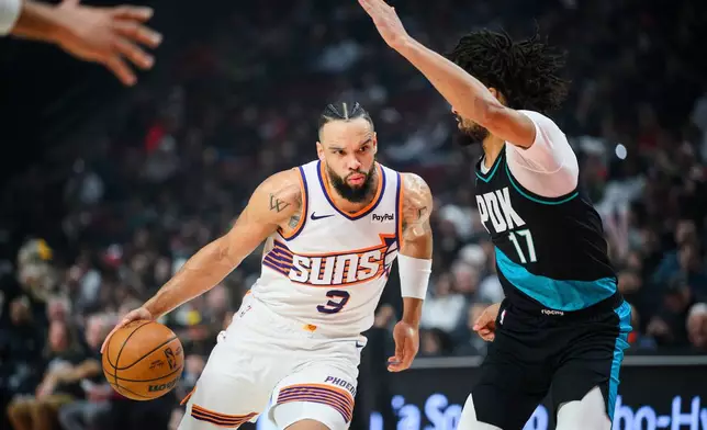 Phoenix Suns guard Dillon Brooks (3) drives past Portland Trail Blazers guard Shaedon Sharpe (17) during the first half of an NBA basketball game on Tuesday, Nov. 18, 2025, in Portland, Ore. (AP Photo/Molly J. Smith)