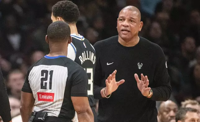 Milwaukee Bucks head coach Doc Rivers, right, talks to referee Dedric Taylor (21) during the first half of an NBA basketball game in Cleveland, Monday, Nov. 17, 2025. (AP Photo/Phil Long)