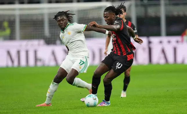 AC Milan's Rafael Leao, right, and Roma's Manu Kone challenge for the ball during the Serie A soccer match between AC Milan and Roma in Milan, Italy, Sunday, Nov. 2, 2025. (AP Photo/Antonio Calanni)