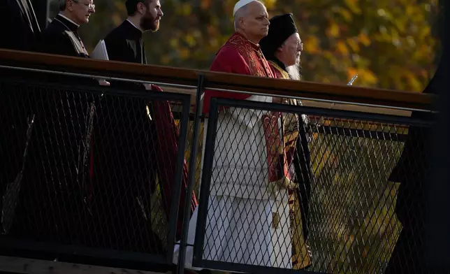Pope Leo XIV, second right, and Ecumenical Patriarch Bartholomew I, the spiritual leader of the world's Eastern Orthodox Christians, right, arrive for an Ecumenical prayer service at archaeological excavations of the ancient Byzantine-era Christian Saint Neophytos Basilica, in Iznik, Turkey, Friday, Nov. 28, 2025, marking the 1,700 years anniversary of the Council of Nicaea. (AP Photo/Khalil Hamra)