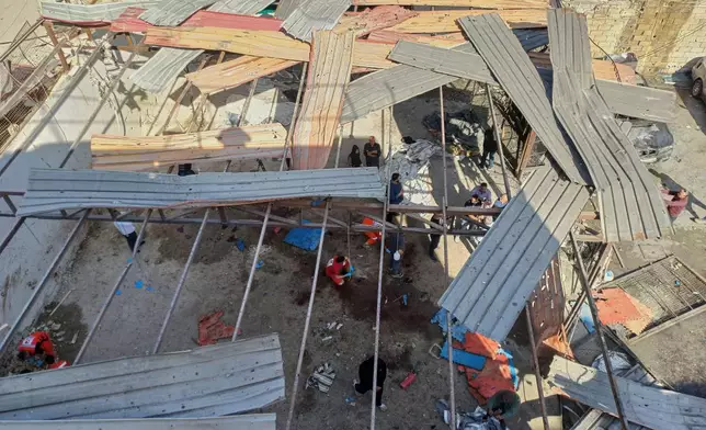 Palestinian rescue workers collect body remains at the scene where an Israeli strike on Tuesday night hit the Ein el-Hilweh Palestinian refugee camp, in the southern port city of Sidon, Lebanon, Wednesday, Nov. 19, 2025. (AP Photo/Mohammed Zaatari)