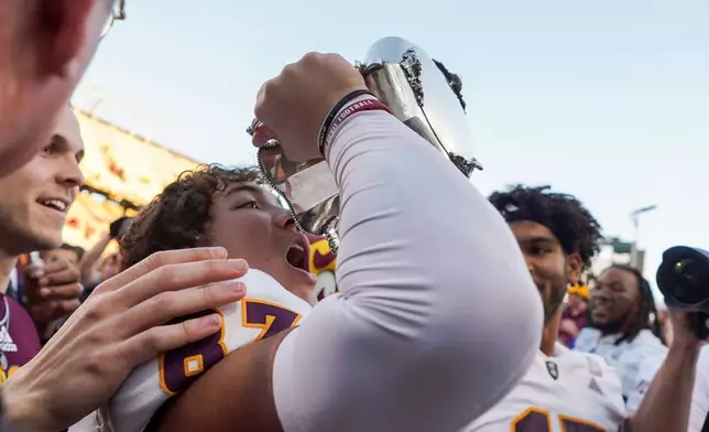 FILE -Arizona State wide receiver Zechariah Sample (87) celebrates with the Territorial Cup after beating Arizona in an NCAA college football game, Nov. 30, 2024, in Tucson, Ariz. (AP Photo/Samantha Chow, File)