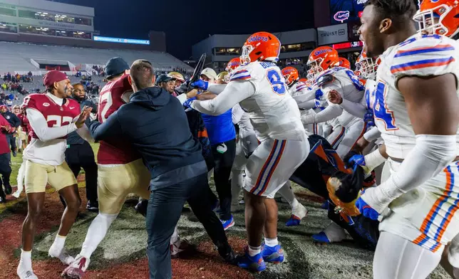 FILE -Florida State and Florida players scuffle at midfield after an NCAA college football game, Nov. 30, 2024, in Tallahassee, Fla. (AP Photo/Colin Hackley, File)