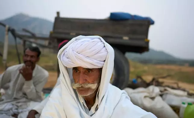 A camel herder attends the annual cattle fair in Pushkar, in the western Indian state of Rajasthan, Monday, Oct. 27, 2025. (AP Photo/Rajesh Kumar Singh)