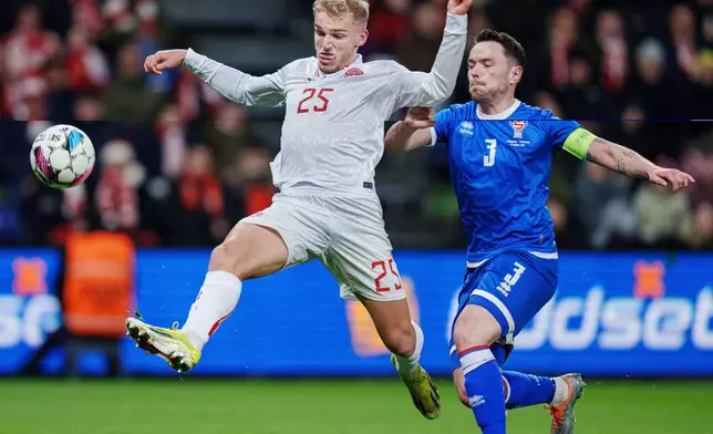 FILE - Denmark's Gustav Isaksen and the Faroe Islands' Viljormur Davidsen battle for the ball during an international friendly soccer at Broendby Stadium, Tuesday, March 26, 2024, in Copenhagen, Denmark. (Liselotte Sabroe/Ritzau Scanpix via AP, File)