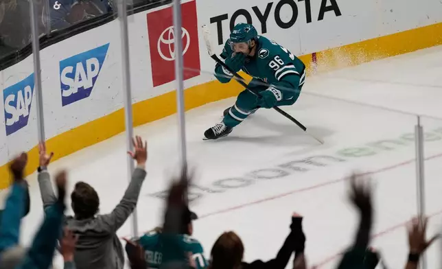 San Jose Sharks center Philipp Kurashev (96) celebrates after scoring the winning goal during overtime of an NHL hockey game against the Colorado Avalanche in San Jose, Calif., Saturday, Nov. 1, 2025. (AP Photo/Jeff Chiu)