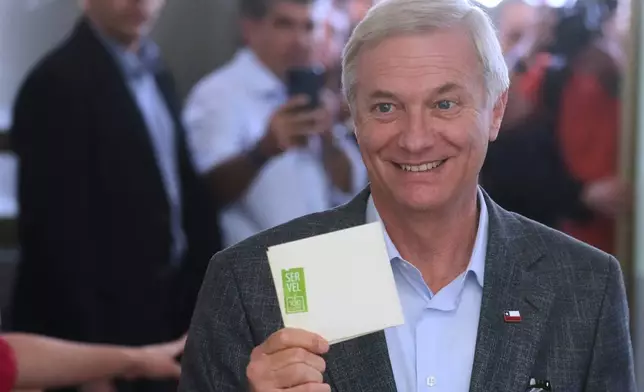 Presidential candidate Jose Antonio Kast of the Republican Party holds up his ballot during general elections in Santiago, Chile, Sunday, Nov. 16, 2025. (AP Photo/Esteban Felix)