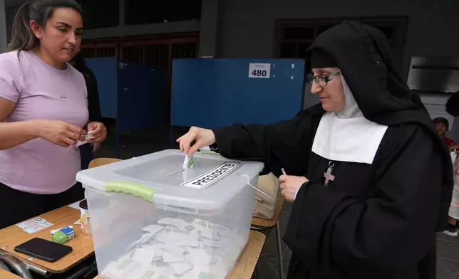 A nun votes during general elections in Santiago, Chile, Sunday, Nov. 16, 2025. (AP Photo/Cristobal Escobar)