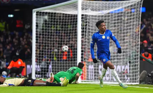 Chelsea's Estevao, right, celebrates after scoring his side's second goal during the Champions League opening phase soccer match between Chelsea and Barcelona in London, England, Tuesday, Nov. 25, 2025. (Bradley Collyer/PA via AP)