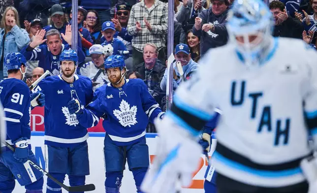 Toronto Maple Leafs' William Nylander (right) celebrates with his team after scoring against the Utah Mammoth during second period NHL hockey action in Toronto, on Wednesday, Nov. 5, 2025. (Sammy Kogan/The Canadian Press via AP)