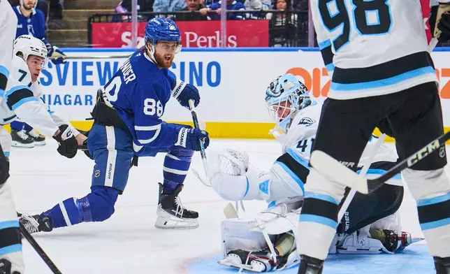 Toronto Maple Leafs' William Nylander (88) scores against the Utah Mammoth goaltender Vitek Vanecek (41) during second period NHL hockey action in Toronto, on Wednesday, Nov. 5, 2025. (Sammy Kogan/The Canadian Press via AP)