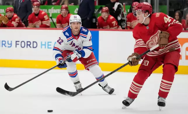 New York Rangers center Jonny Brodzinski, left, chases Detroit Red Wings defenseman Axel Sandin-Pellikka during the third period of an NHL hockey game, Friday, Nov. 7, 2025, in Detroit. (AP Photo/Ryan Sun)