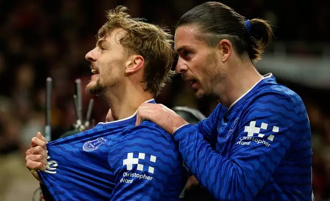 Everton's Kiernan Dewsbury-Hall, left, celebrates with Jack Grealish after scoring the opening goal during the English Premier League soccer match between Manchester United and Everton in Manchester, England, Monday, Nov. 24, 2025. (AP Photo/Dave Thompson)