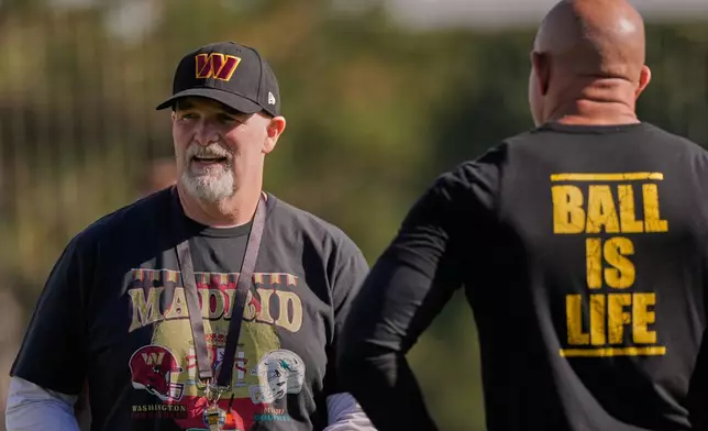 Washington Commanders head coach Dan Quinn, left, during a training session in Madrid, Spain, Wednesday, Nov. 12, 2025, ahead of Sunday's NFL football game against Miami Dolphins. (AP Photo/Bernat Armangue)