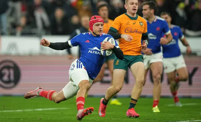 France's Louis Bielle-Biarrey crosses the line to score a try during the rugby union Nations Series match between France and Australia in Saint-Denis, outside Paris, Saturday, Nov. 22, 2025. (AP Photo/Christophe Ena)