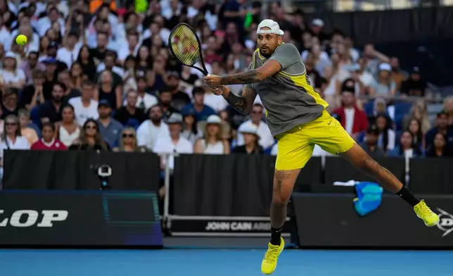 FILE - Nick Kyrgios of Australia plays a backhand return to Jacob Fearnley of Britain during their first round match at the Australian Open tennis championship in Melbourne, Australia, Monday, Jan. 13, 2025. (AP Photo/Ng Han Guan, file)