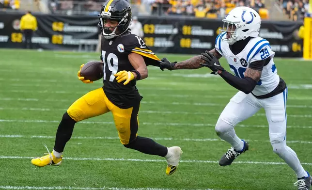 Indianapolis Colts cornerback Mekhi Blackmon (29) tries to bring down Pittsburgh Steelers wide receiver Calvin Austin III (19) during the first half of an NFL football game in Pittsburgh, Sunday, Nov. 2, 2025. (AP Photo/Gene J. Puskar)