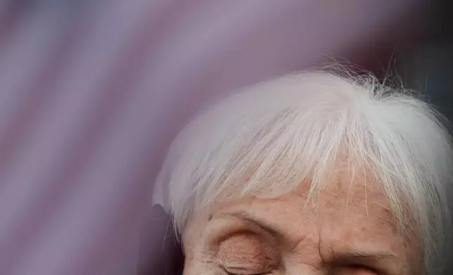 A protester prays outside an ICE processing facility in the Chicago suburb of Broadview, Ill., Friday, Nov. 14, 2025. (AP Photo/Nam Y. Huh)
