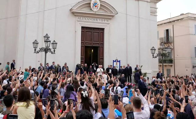 FILE - Pope Leo XIV is greeted by faithful as he arrives at the St. Thomas of Villanova Church to celebrate a mass, in Castel Gandolfo, on the outskirts of Rome, Aug.15, 2025. (AP Photo/Gregorio Borgia, File)