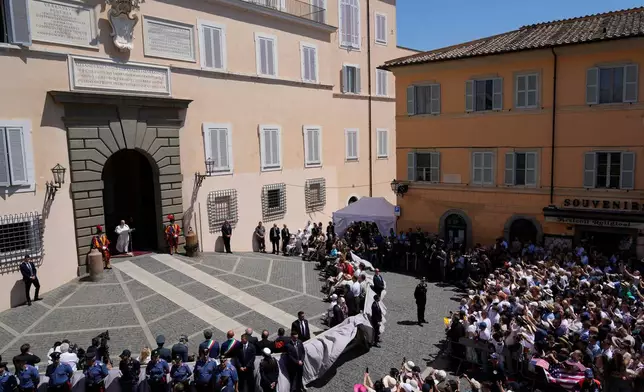 FILE - Pope Leo XIV blesses the faithful gathered in the square in front of the Apostolic Palace for the noon Angelus prayer in Castel Gandolfo, Italy, July 20, 2025. (AP Photo/Gregorio Borgia, File)