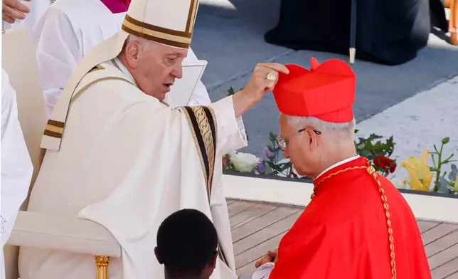 FILE - Newly elected Cardinal Robert Francis Prevost, Prefect of the Dicastery for Bishops, right, receives his biretta from Pope Francis as he is elevated in St. Peter's Square at The Vatican, Sept. 30, 2023. (AP Photo/Riccardo De Luca, File)