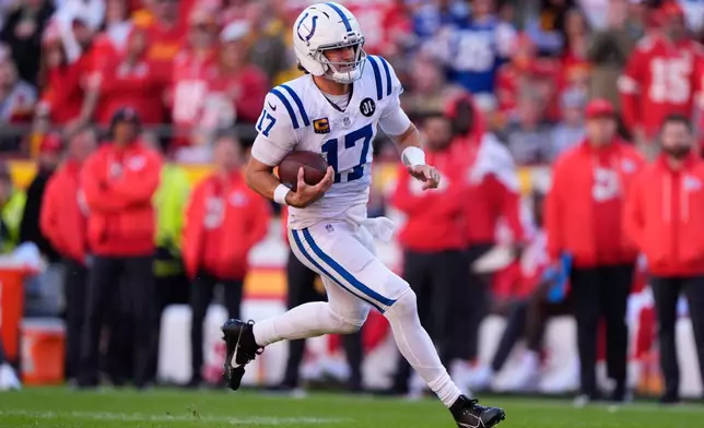 Indianapolis Colts quarterback Daniel Jones (17) runs for a first down against the Kansas City Chiefs during the second half of an NFL football game Sunday, Nov. 23, 2025, in Kansas City, Mo. (AP Photo/Charlie Riedel)