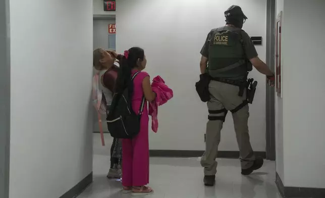 The wife and daughters of an asylum seeker from Ecuador cry after he was detained in immigration court, Thursday. July 31, 2025, in New York. (AP Photo/Olga Fedorova)