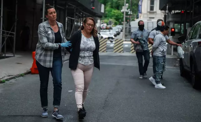 Federal agents escort handcuffed detainees after arresting them during a regular check-in with U.S. Immigration and Customs Enforcement, Wednesday, June 4, 2025, in New York. (AP Photo/Olga Fedorova)