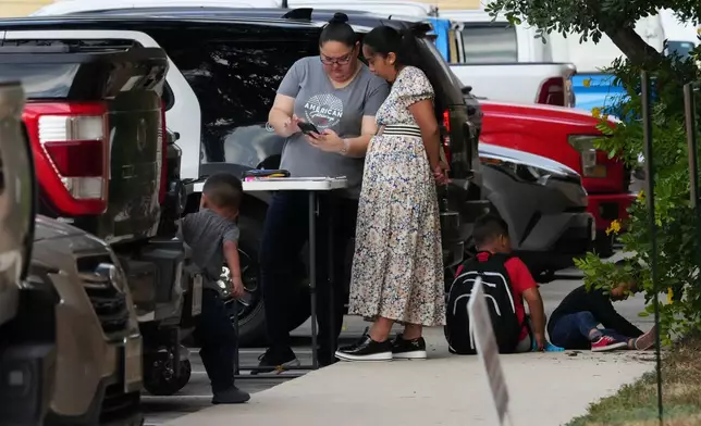 American Gateways attorney Erika Gonzalez talks with a woman before she attends her court hearing, Wednesday, Sept. 24, 2025, in San Antonio. (AP Photo/Eric Gay)