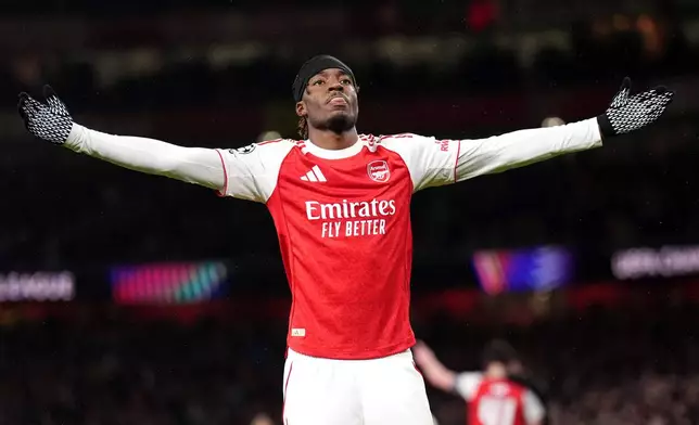 Arsenal's Noni Madueke celebrates after scoring his side's second goal during the Champions League opening phase soccer match between Arsenal and Bayern Munich in London, Wednesday, Nov. 26, 2025. (John Walton/PA via AP)