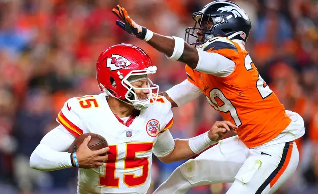 Denver Broncos cornerback Ja'Quan McMillian, right, sacks Kansas City Chiefs quarterback Patrick Mahomes (15) during the second half an NFL football game Sunday, Nov. 16, 2025, in Denver. (AP Photo/Jack Dempsey)