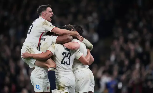 England George Ford, left, with teammates celebrates after Fraser Dingwall scored a try during the rugby union Nations Series match between England and New Zealand in London, Saturday, Nov. 15, 2025. (AP Photo/Kin Cheung)