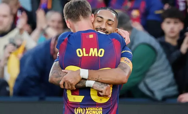 Barcelona's Dani Olmo, back, celebrates after scoring his side's second goal during a Spanish La Liga soccer match between Barcelona and Alaves, in Barcelona, Spain, Saturday, Nov. 29, 2025. (AP Photo/Joan Monfort)