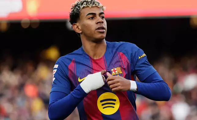 Barcelona's Lamine Yamal celebrates after scoring his side's first goal during a Spanish La Liga soccer match between Barcelona and Alaves, in Barcelona, Spain, Saturday, Nov. 29, 2025. (AP Photo/Joan Monfort)