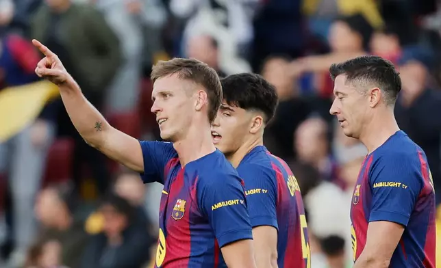 Barcelona's Dani Olmo celebrates after scoring his side's second goal during a Spanish La Liga soccer match between Barcelona and Alaves, in Barcelona, Spain, Saturday, Nov. 29, 2025. (AP Photo/Joan Monfort)