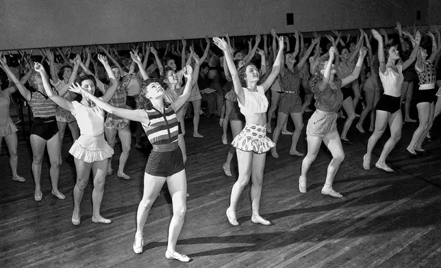 FILE — Radio City Music Hall Rockettes, Corliss Fyfe, Eleanor Dunne, Ginnie Volmer and Pat White, rehearse on June 13, 1951, in New York. (AP Photo/Dan Grossi, File)