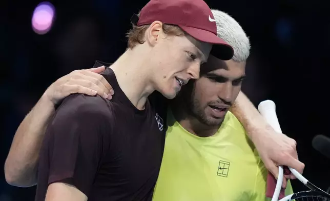 Italy's Jannik Sinner, left, and Spain's Carlos Alcaraz hug after the final tennis match of the ATP World Tour Finals, in Turin, Italy, Sunday, Nov. 16, 2025. (AP Photo/Antonio Calanni)