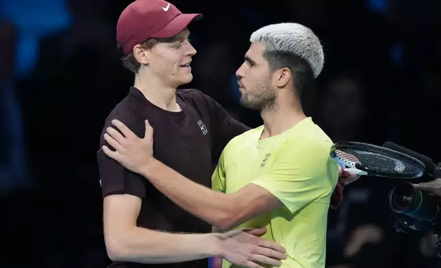 Italy's Jannik Sinner, left, and Spain's Carlos Alcaraz hug after the final tennis match of the ATP World Tour Finals, in Turin, Italy, Sunday, Nov. 16, 2025. (AP Photo/Antonio Calanni)