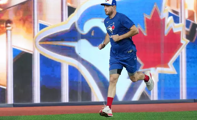 Toronto Blue Jays pitcher Max Scherzer warms up during practice ahead of game 6 of the World Series against the Los Angeles Dodgers in Toronto on Thursday, Oct. 30, 2025. (Nathan Denette/The Canadian Press via AP)