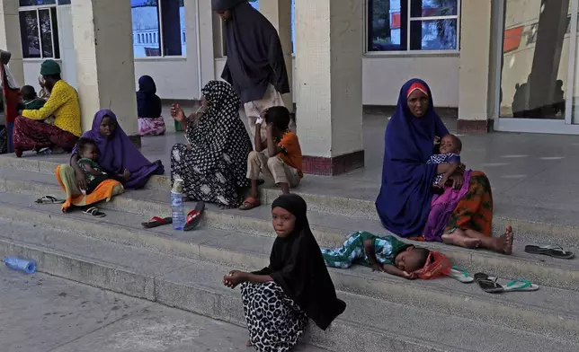 Patients sit at the entrance of Banadir Hospital in Mogadishu, Somalia, on Tuesday, Nov. 11, 2025. (AP Photo/Farah Abdi Warsameh)