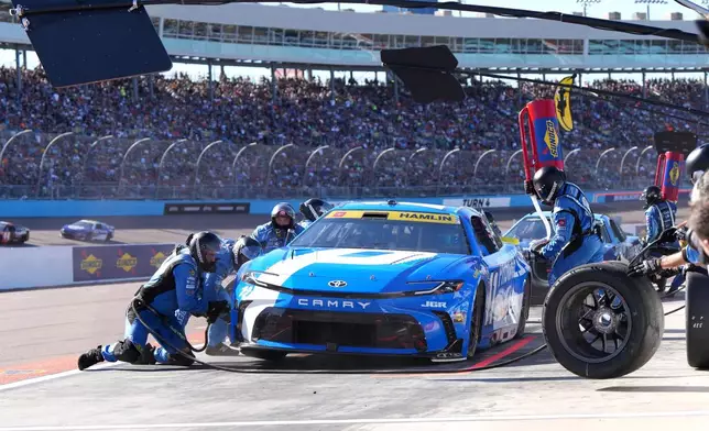 Denny Hamlin makes a pit stop on lap 63 during a NASCAR Cup Series auto race Sunday, Nov. 2, 2025, in Avondale, Ariz. (AP Photo/Rick Scuteri)