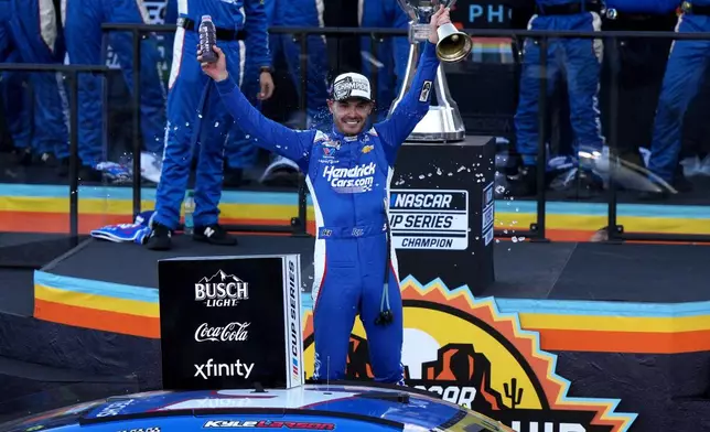 Kyle Larson celebrates after winning the NASCAR Cup Series championship Sunday, Nov. 2, 2025, in Avondale, Ariz. (AP Photo/Rick Scuteri)